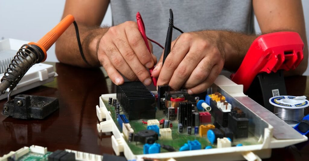 Technician skillfully repairing an electronic circuit board with various tools on a wooden table.