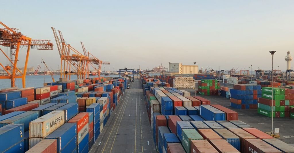 A bustling port scene with colorful cargo containers at sunrise. Ideal for logistics concepts.
