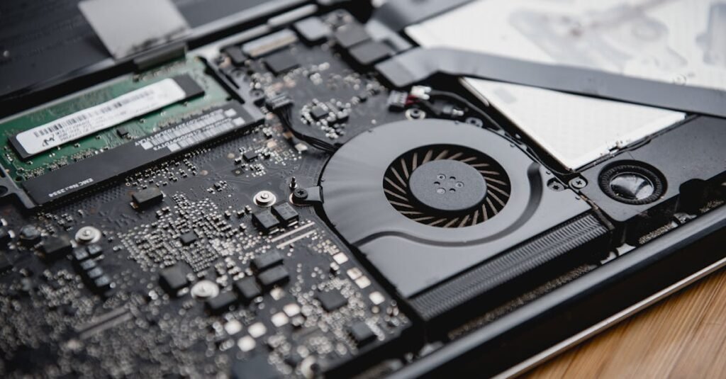 Detailed view of a laptop's internal circuitry and cooling fan showcasing technology and engineering.