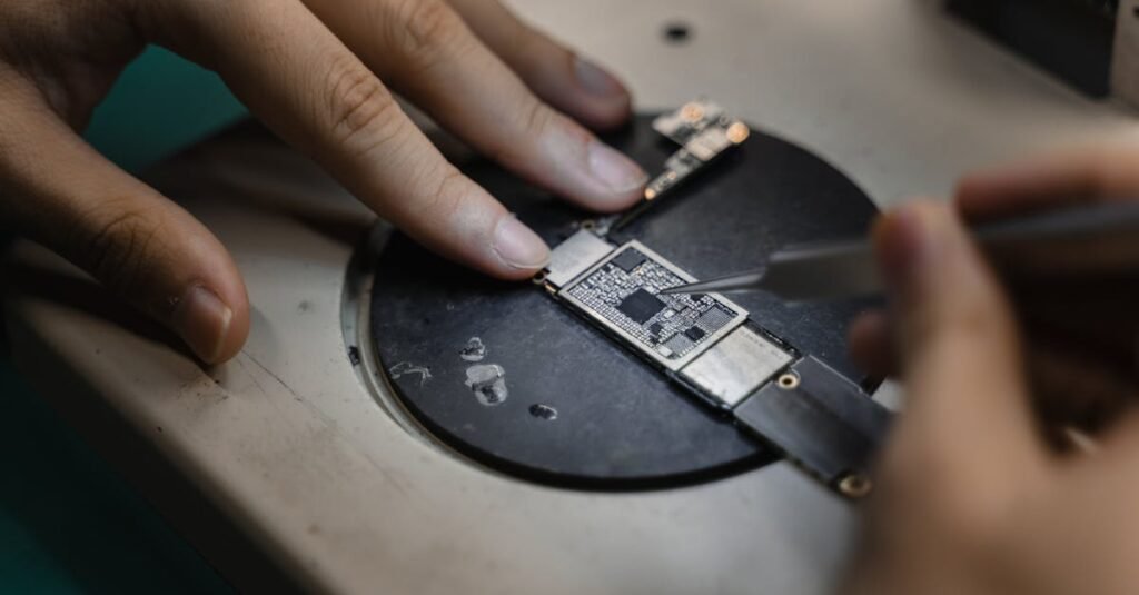 Detailed view of hands soldering electronic components, showcasing precision in engineering.