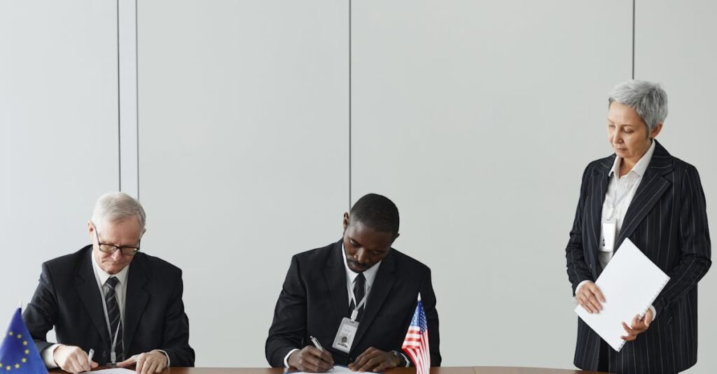 Executives signing international agreement with EU and US flags displayed on a wooden table.
