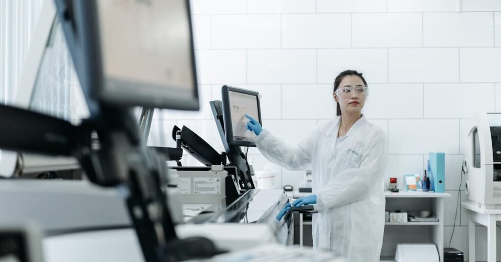 Lab technician in a white coat using medical equipment in a modern laboratory setting.