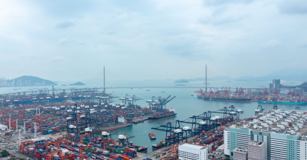 Overhead view of bustling container port in Hong Kong's New Territories, showcasing industrial marine activity.