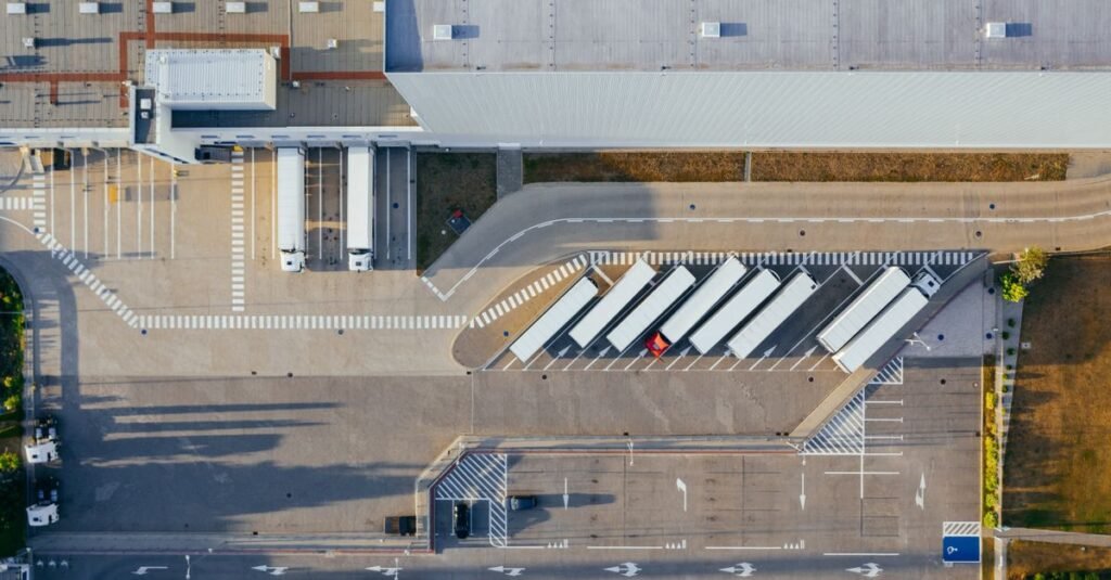 Drone shot of a logistics center with trucks and parking lot in Poznań, Poland.