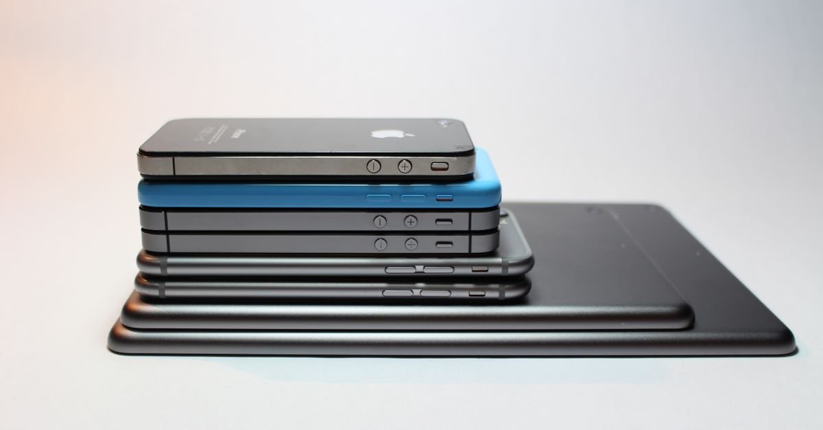 Stacked modern smartphones and tablets showcasing sleek design. Perfect tech background.