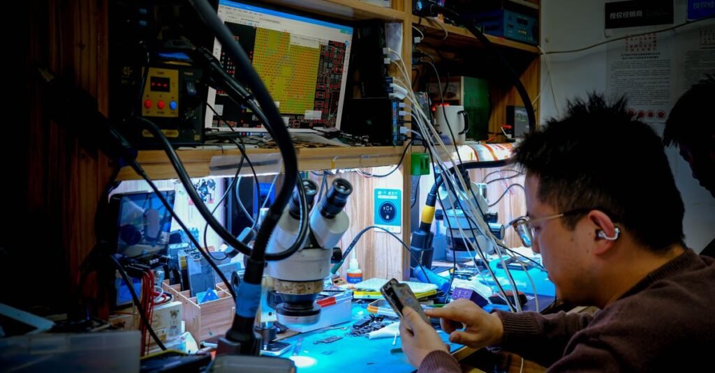 A technician diligently repairs a circuit board at a well-equipped workstation using advanced tools and equipment.
