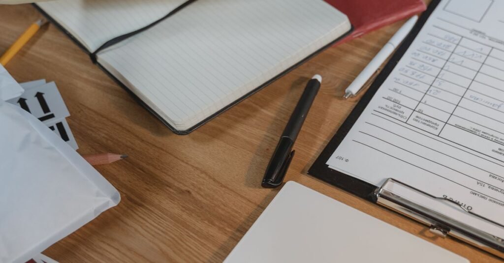 A well-organized desk with delivery packages, clipboard and coffee.