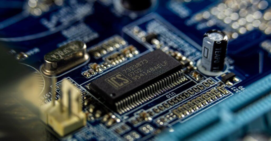 Detailed shot of a microprocessor on a blue motherboard showcasing electronic components.