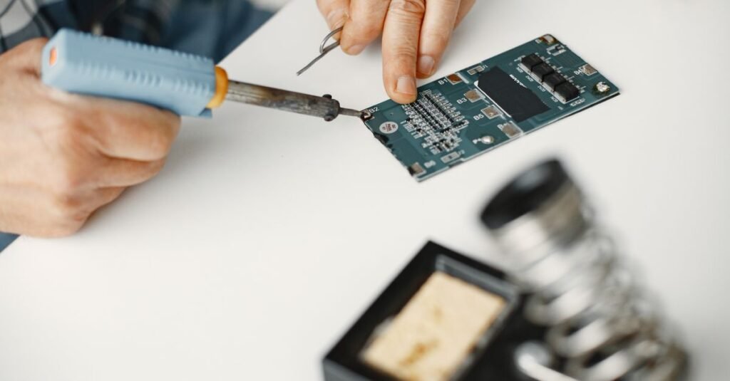 Detailed view of soldering work on a circuit board, highlighting precision in electronics repair.