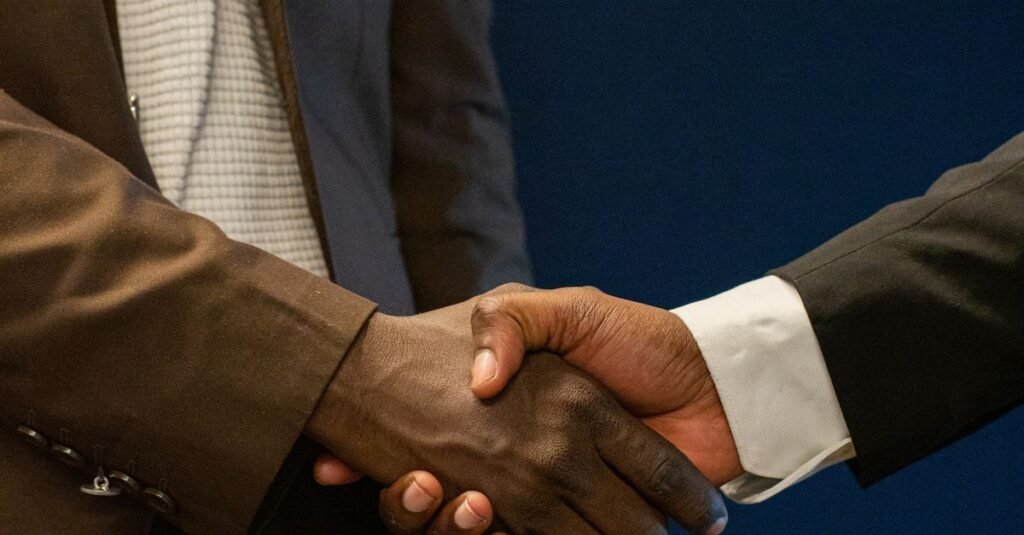 Close-up of two business professionals shaking hands, symbolizing a successful partnership.