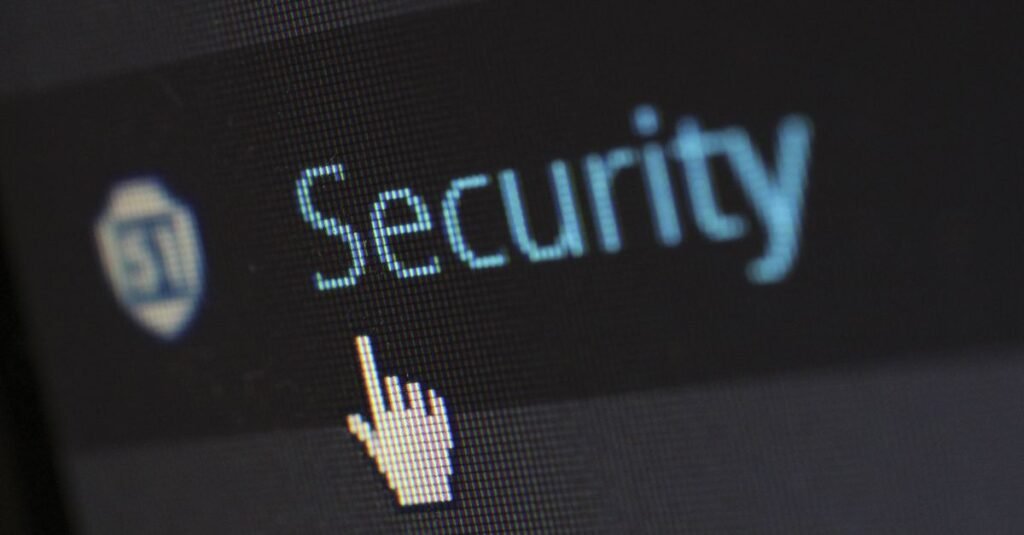 Close-up view of a mouse cursor over digital security text on display.